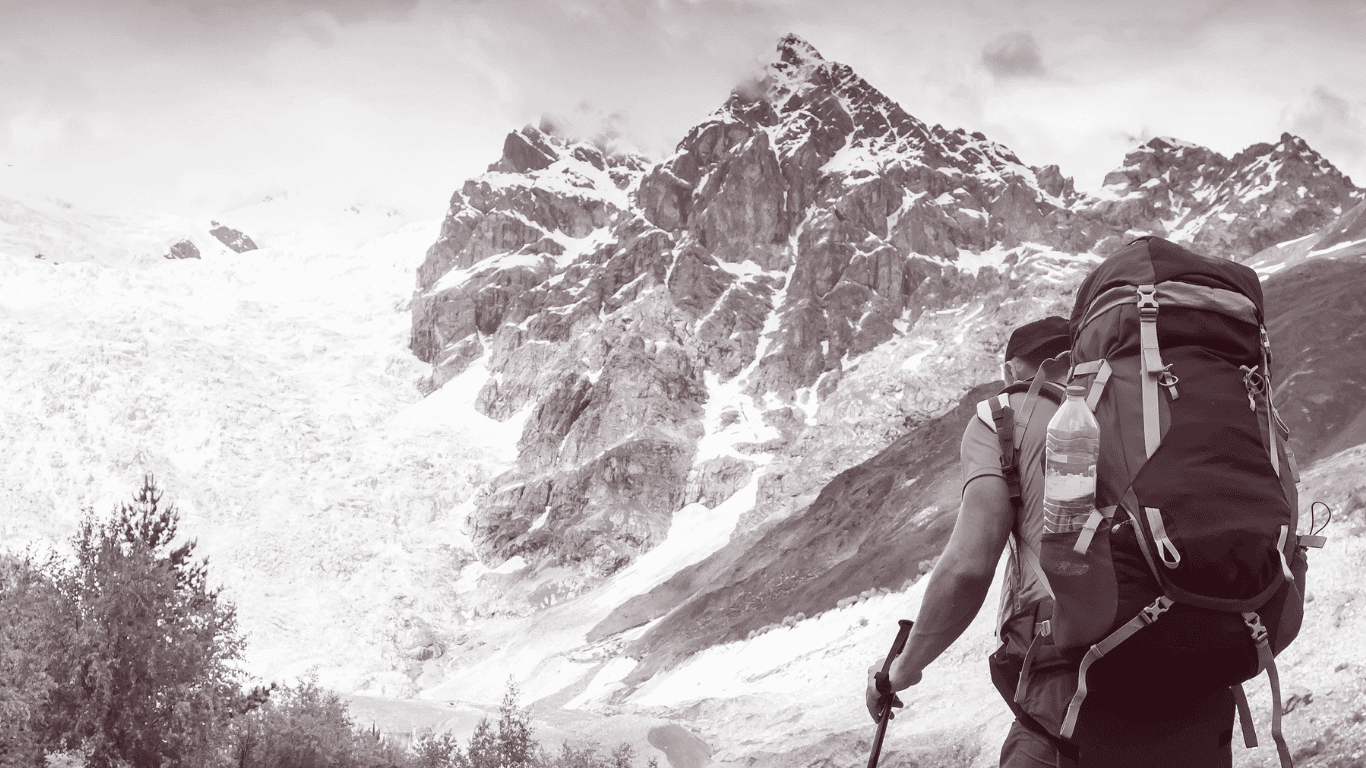 AltairClub travelers trekking toward a snowy Himalayan range
